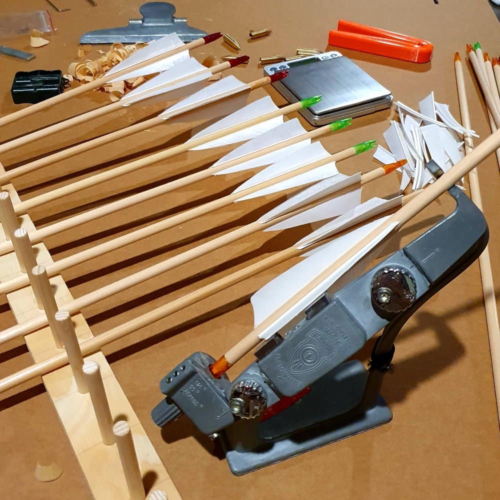 Close-up of wooden arrow shafts during the crafting process, highlighting the precision and grain matching of Port Orford Cedar.