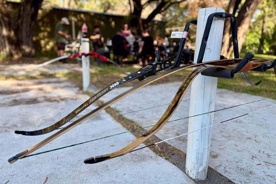 A step-by-step guide to setting up a takedown recurve bow, featuring all bow components ready for assembly.